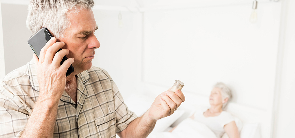 A man holding something in his hand while looking at an older woman.